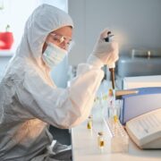 Scientist in a hazmat suit conducting research on a highly pathogenic coronavirus