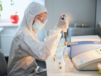 Scientist in a hazmat suit conducting research on a highly pathogenic coronavirus